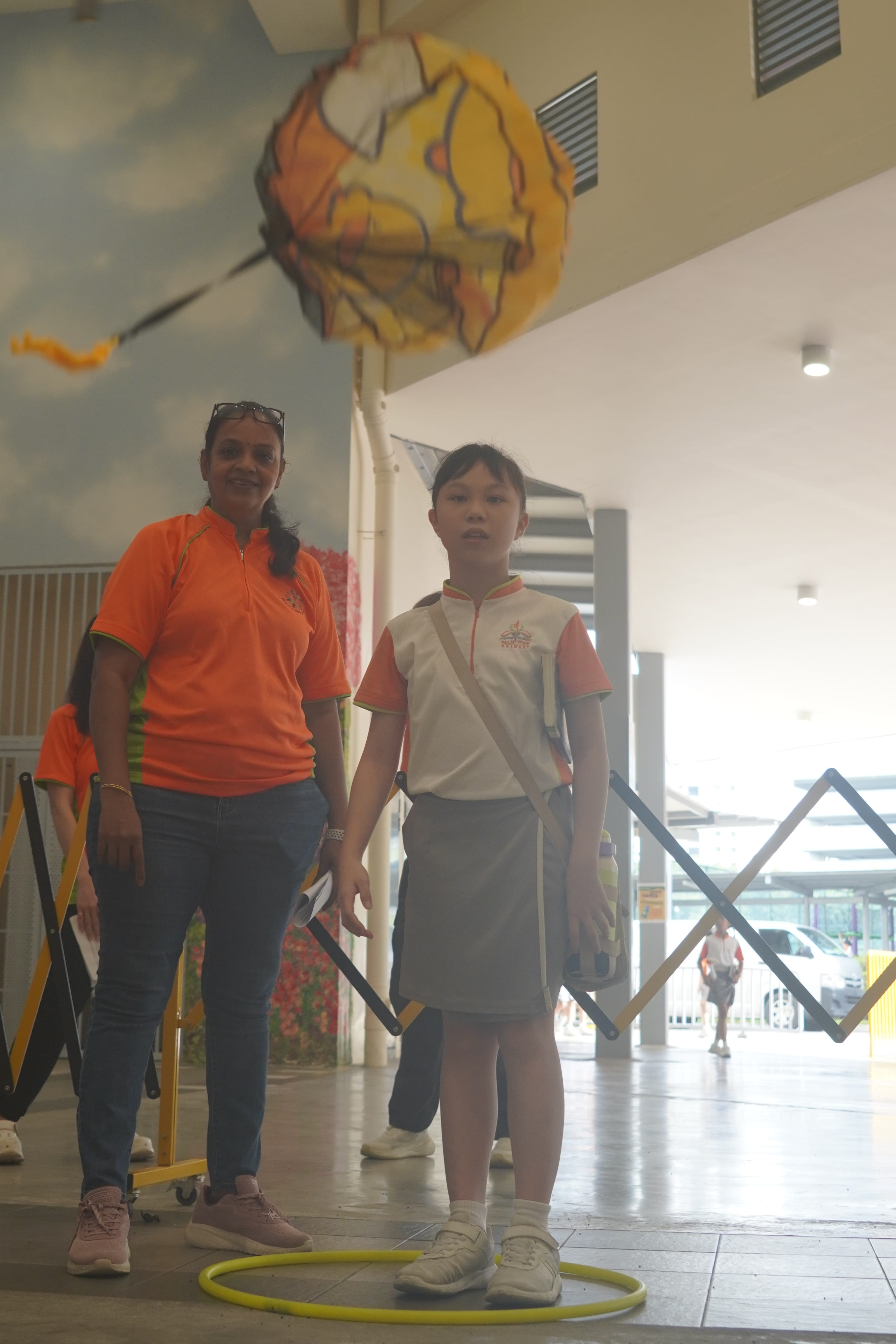 A girl throwing a paper parachute into the air